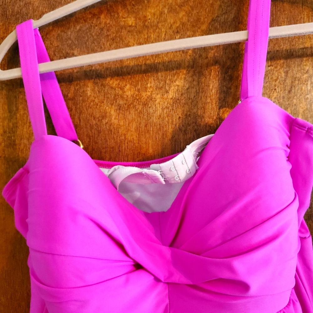 Super cute Swimdress. Has built-in padded bra with adjustable gold straps.
